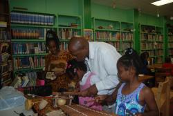 DaraMonifa Cooper (left) and Myron Jackson help Lorniesha Henley and Shaleah Roberts play traditional African instruments. DaraMonifa Cooper (left) and Myron Jackson help Lorniesha Henley and Shaleah Roberts play traditional African instruments.